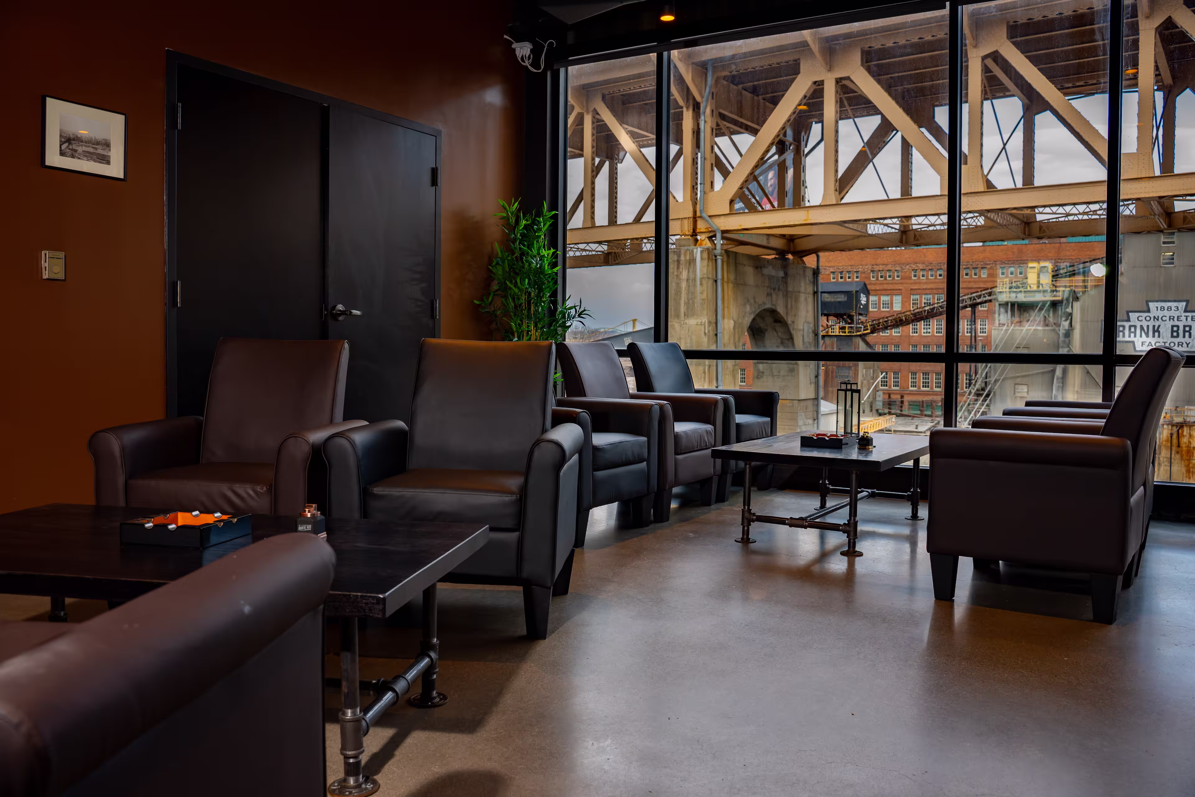 Cigar lounge featuring comfortable chairs and floor to ceiling windows