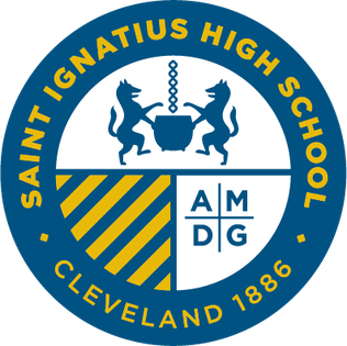 Saint Ignatius High School round emblem with two lions holding a cauldron, yellow diagonal stripes, and AMDG initials, bordered in blue with school name and Cleveland 1886 text.