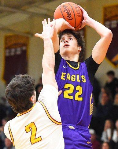 High school basketball player in a purple Eagles jersey number 22 jumps to shoot while a player in a white jersey number 2 defends.