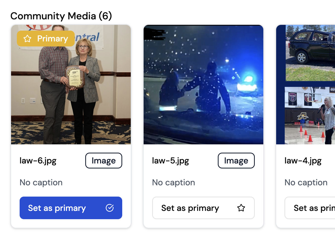 Two people standing indoors, one holding a plaque or award.