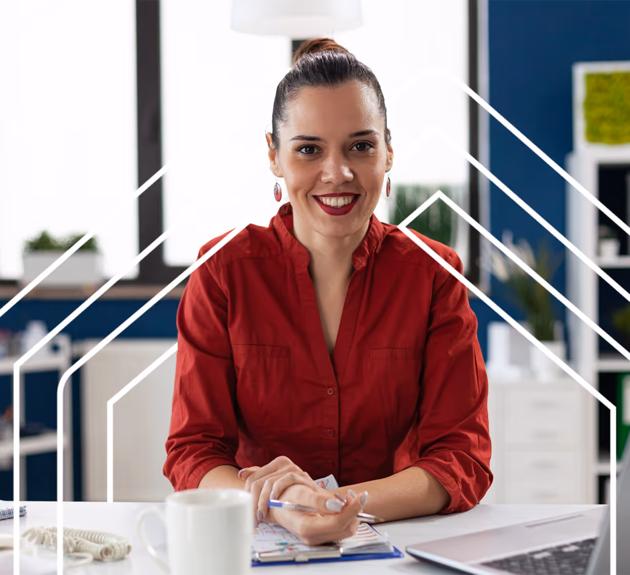 woman sitting at desk smiling and working