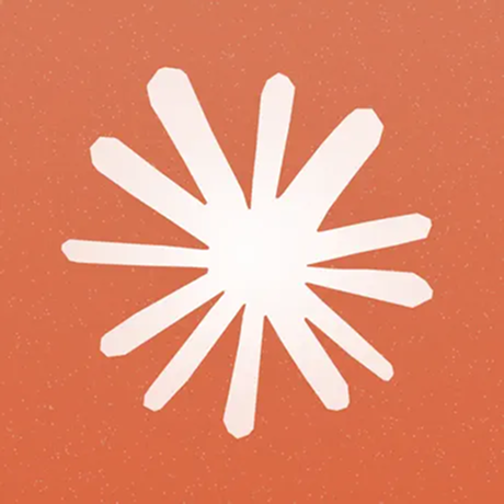 White abstract sunburst shape with uneven rays on a speckled orange background.