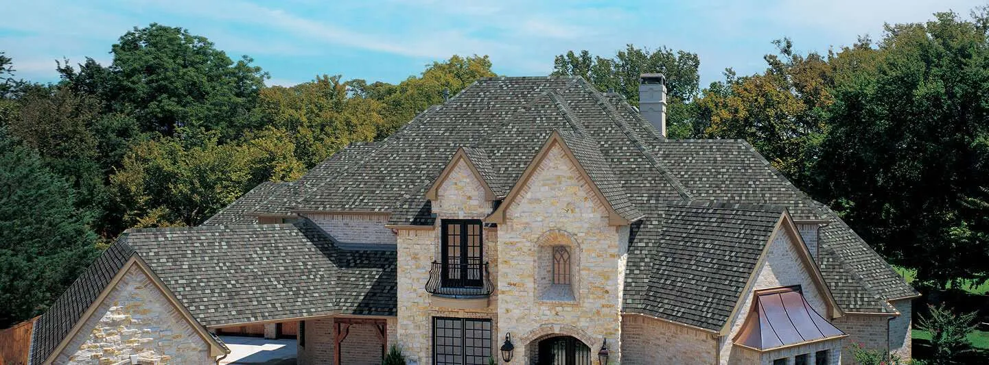 TAMKO Titan XT Class 3 impact-resistant shingles on large stone home