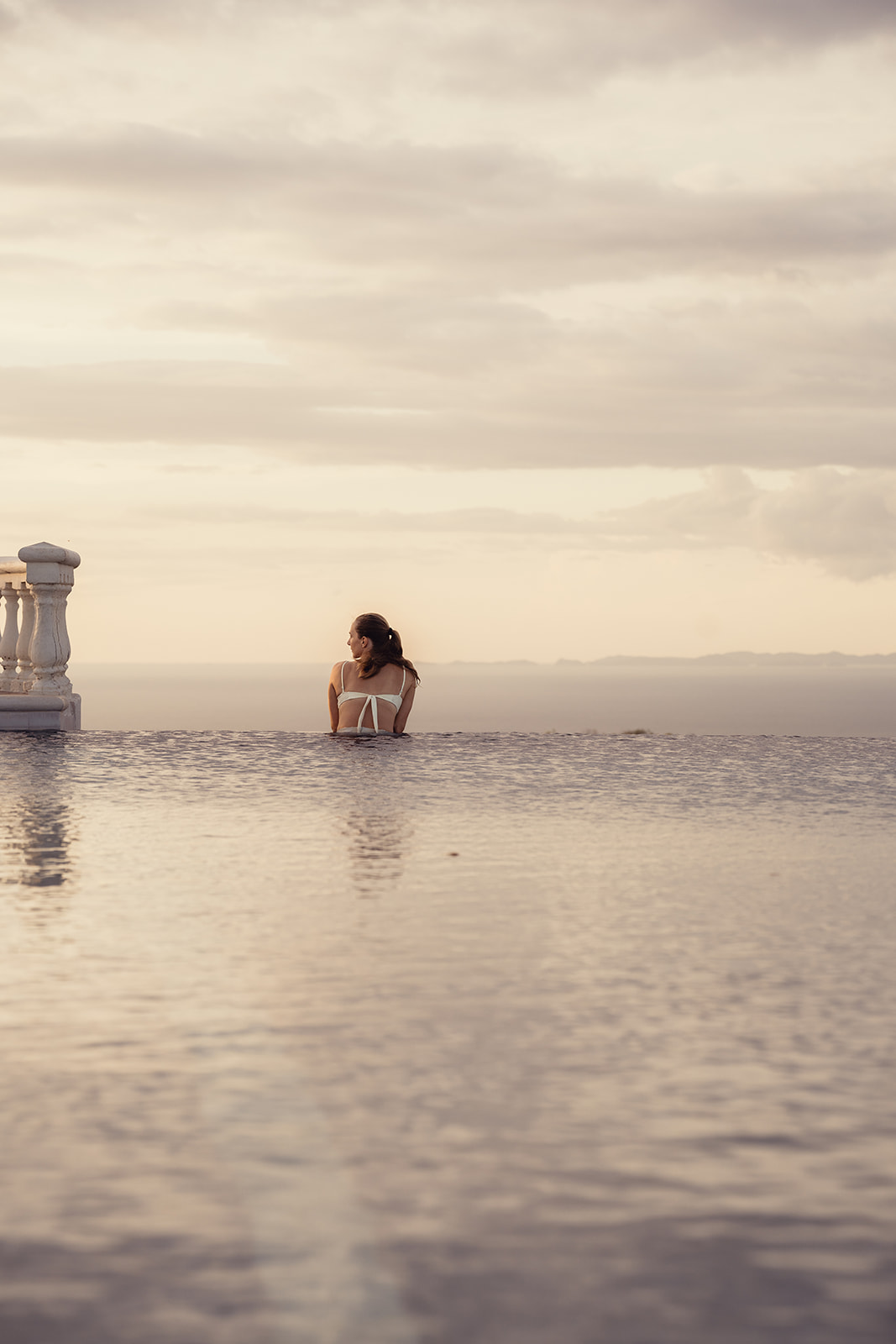 Woman enjoying a quiet moment in an infinity pool