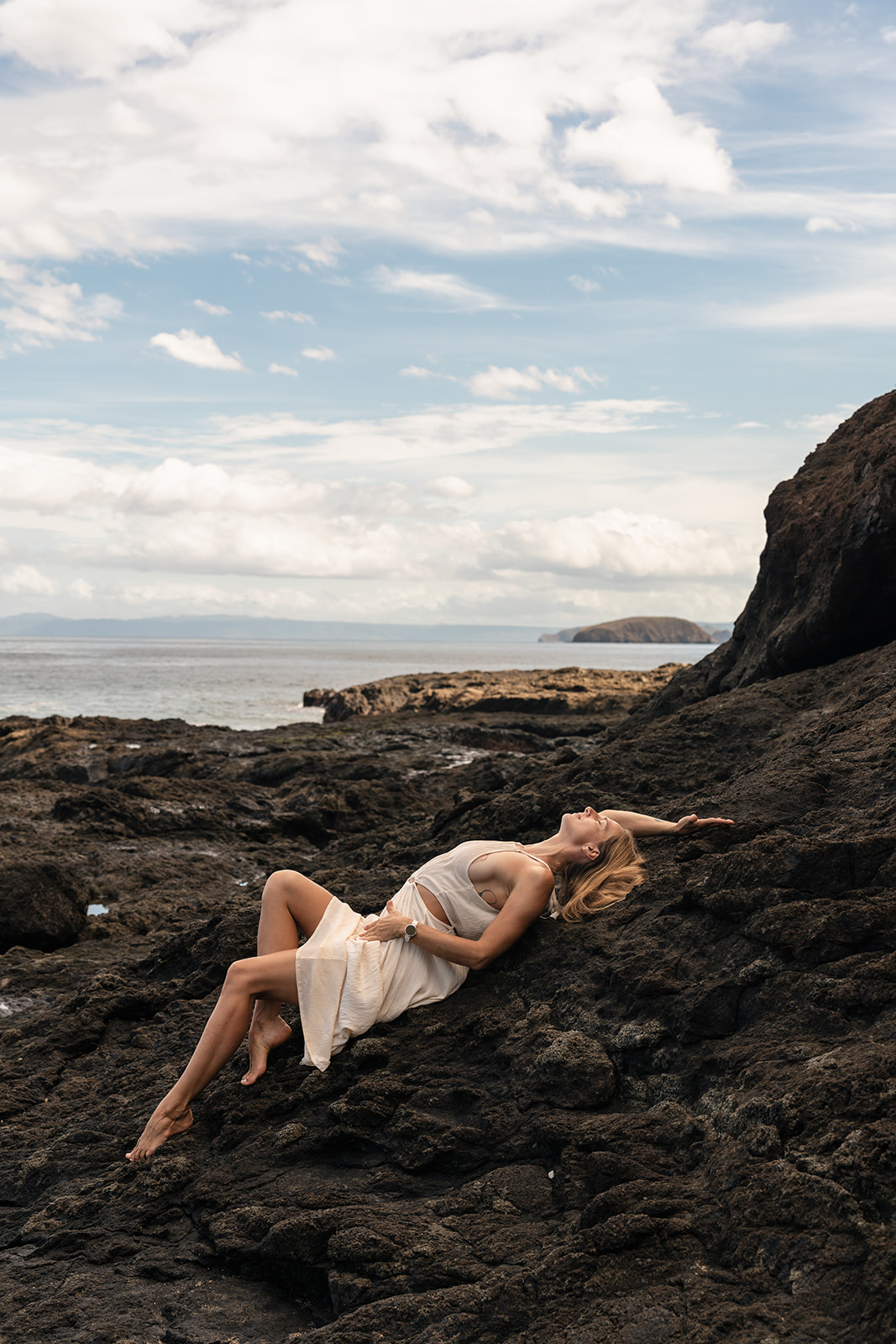 Woman relaxing beside the ocean in Costa Rica