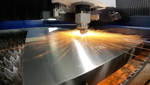 a close up of a metal cutting machine with sparks coming out of it