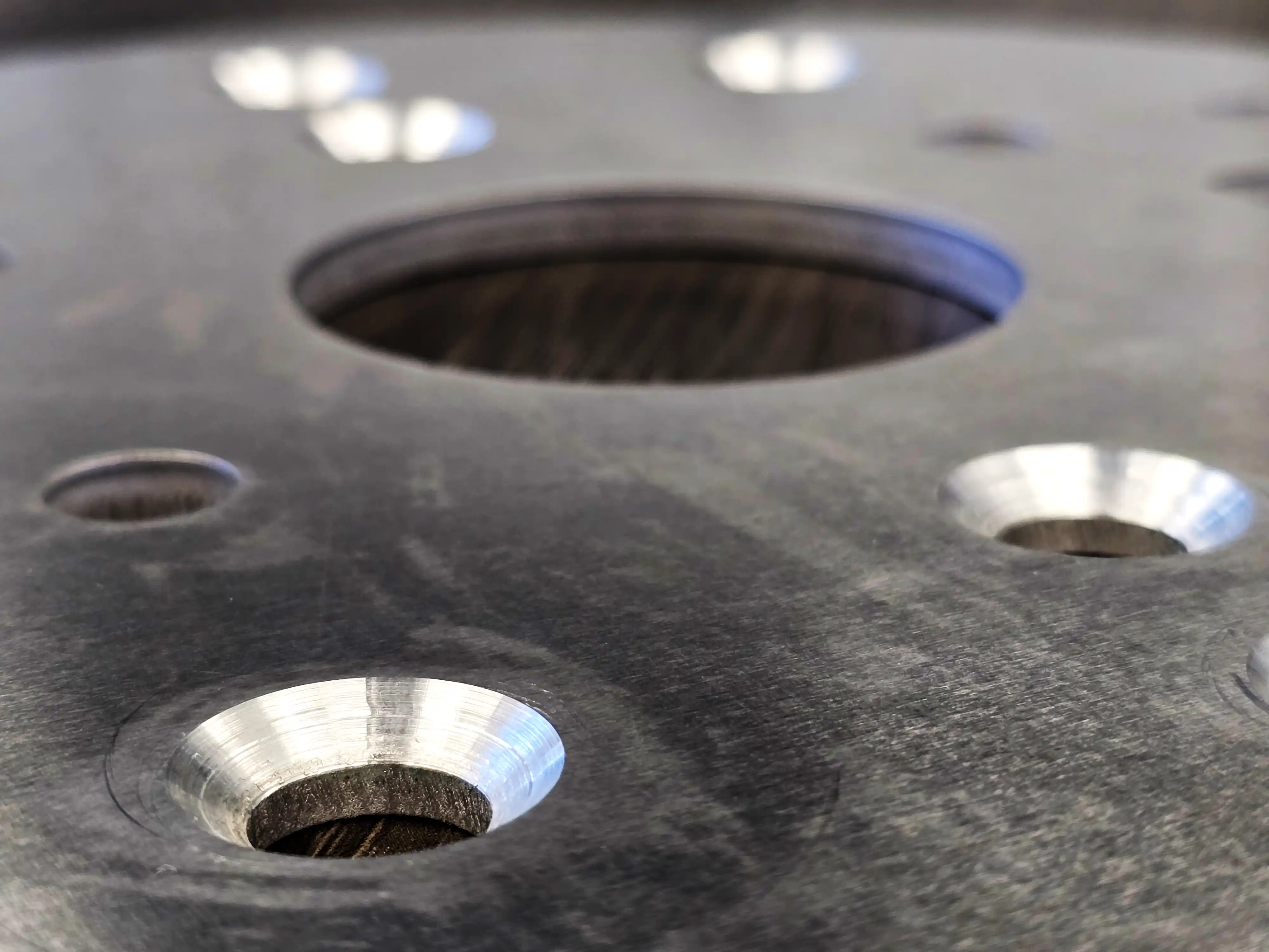 Close-up of countersunk holes in a metal plate