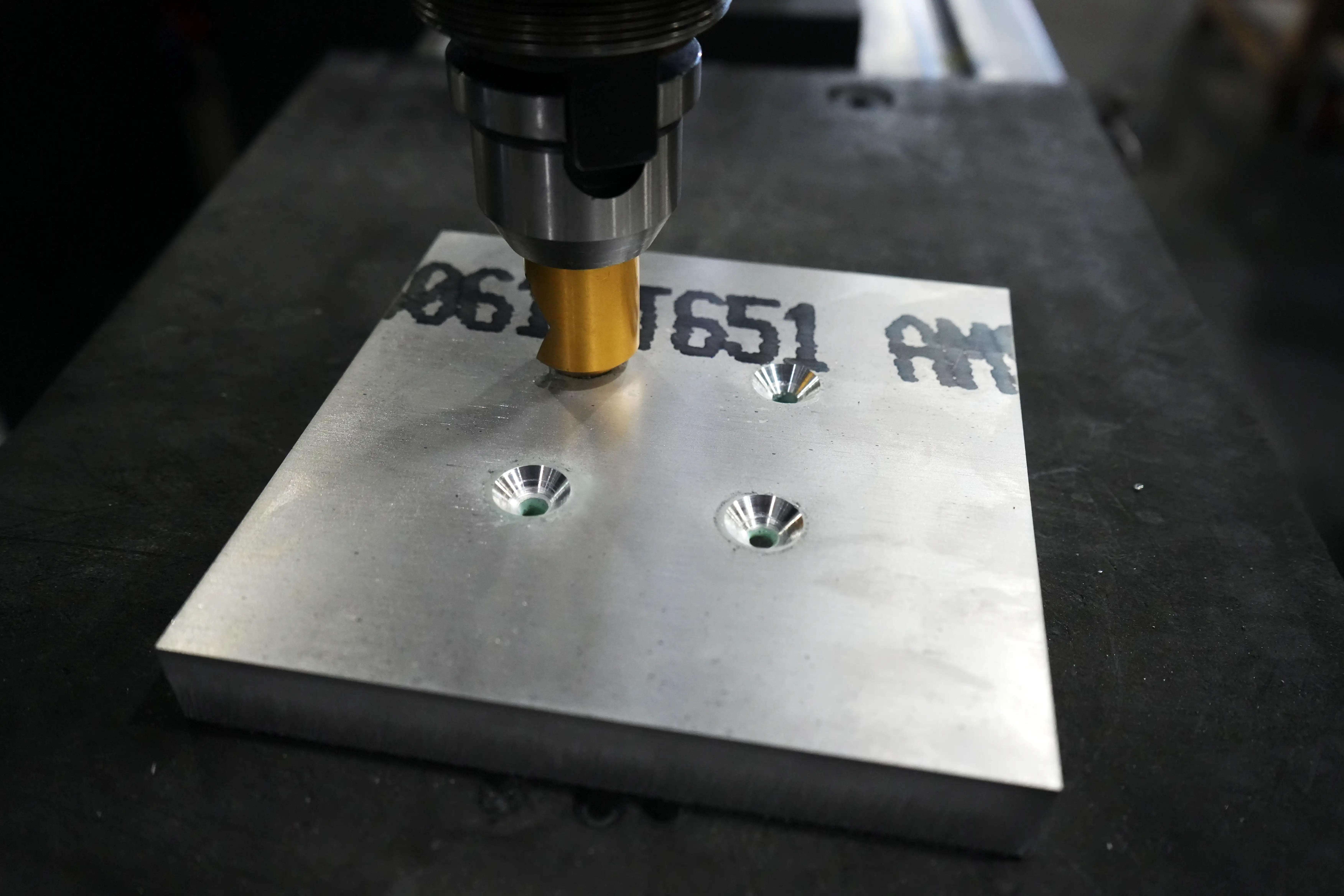Countersink tool cutting holes in a thick 6061 aluminum plate