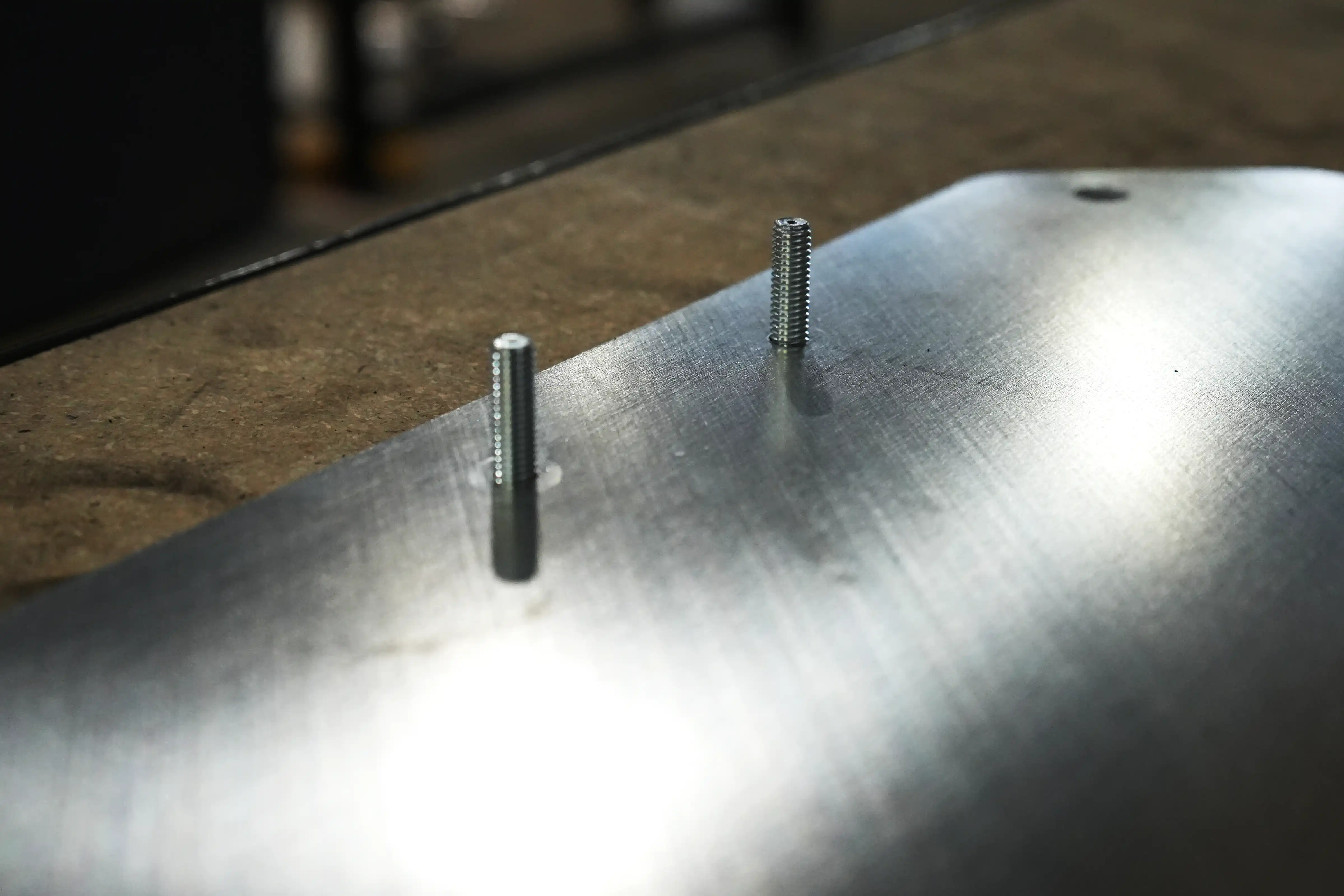 Two threaded studs installed in a sheet metal panel