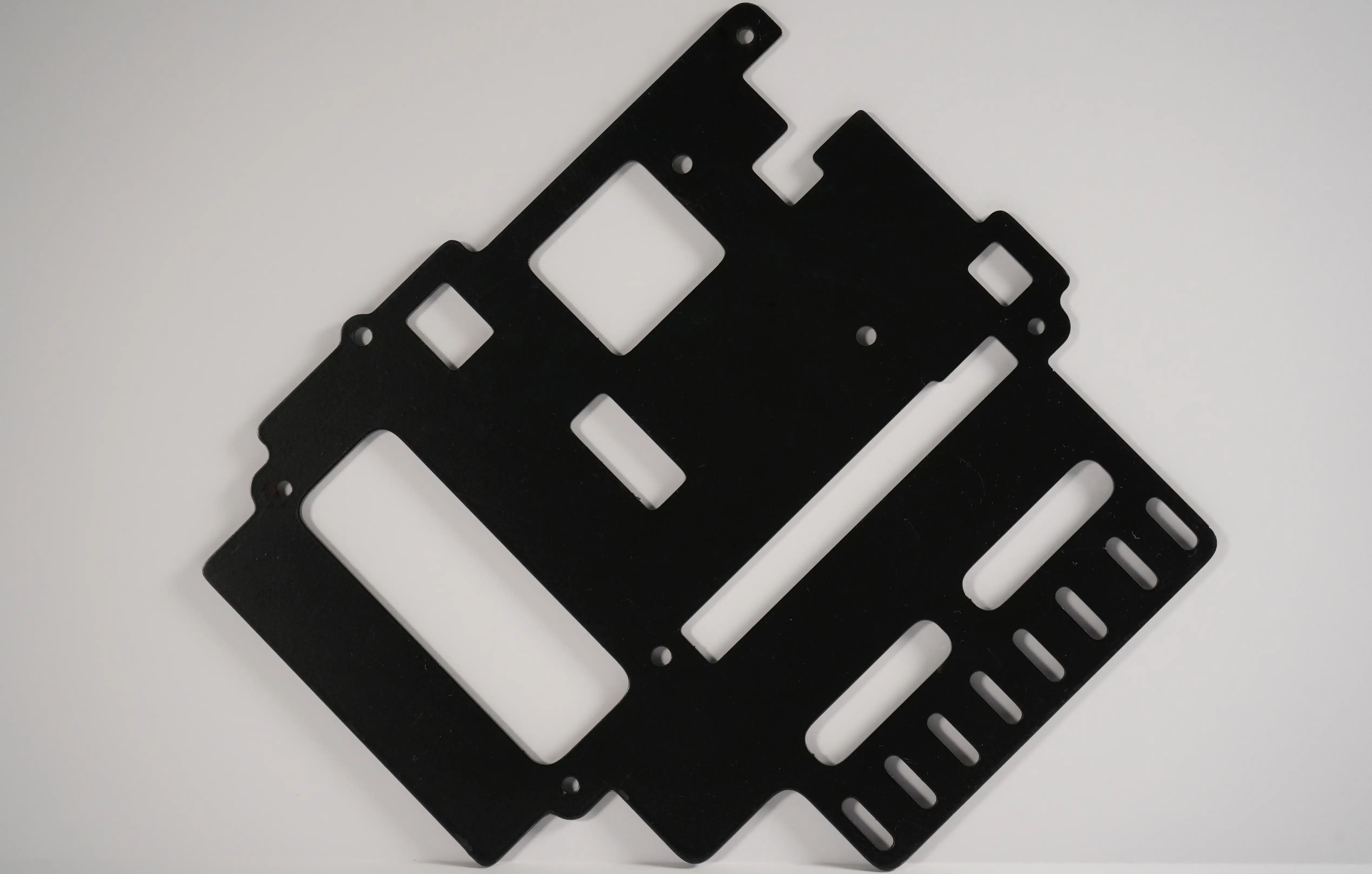 Black powder-coated sheet metal frame with cutouts