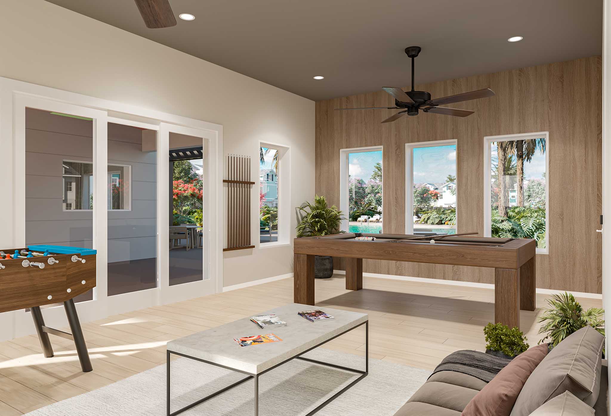 Modern game room with foosball table, pool table, sofa, coffee table, and large windows with garden view.