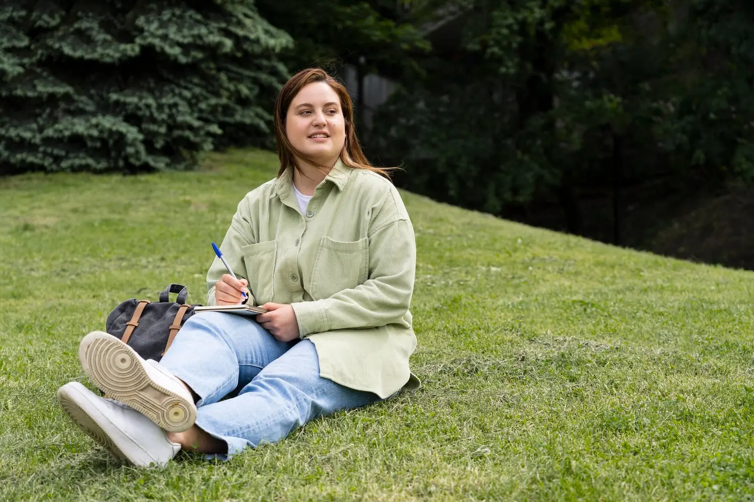 Person in recovery journaling outdoors after completing withdrawal management as part of ongoing addiction treatment