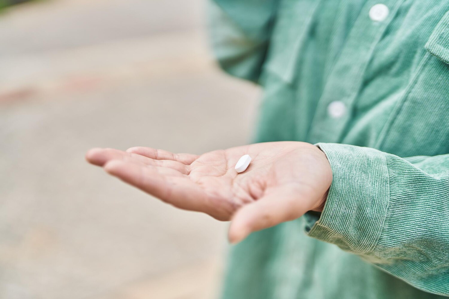 Person holding prescribed medication used during medication-assisted detox to manage withdrawal symptoms safely