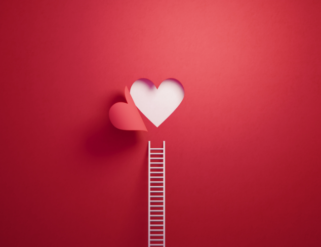 Paper-cut style illustration of a small white ladder leading up to a pink and white heart on a red background.