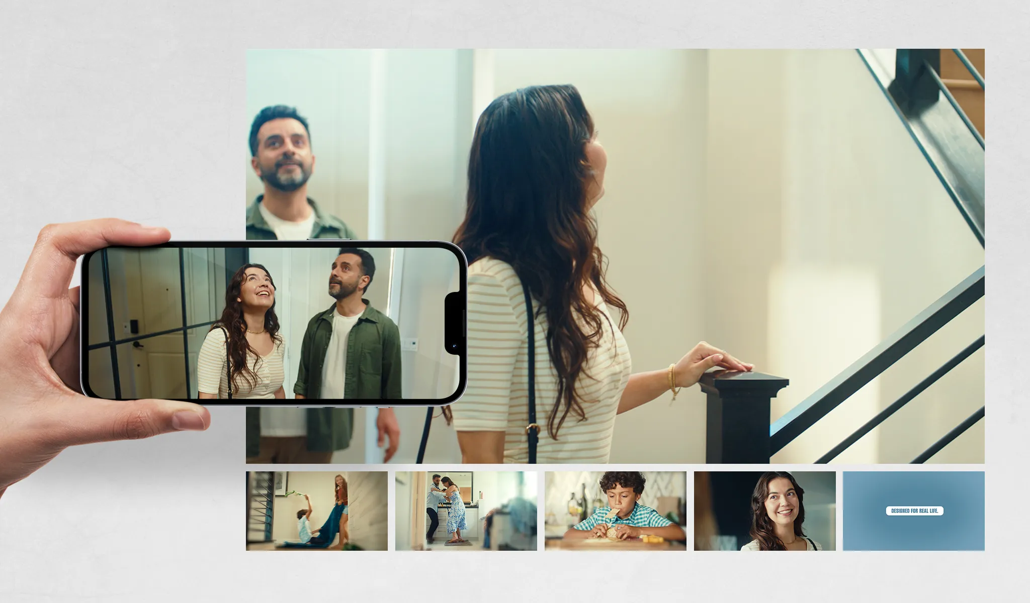 A couple smiles while exploring a home, captured on a smartphone. Other images show family moments. Text reads "DESIGNED FOR REAL LIFE."