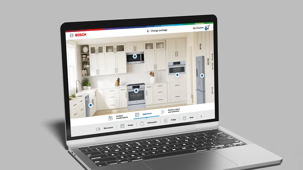 A laptop displaying the Bosch kitchen visualizer tool, showing an interactive white kitchen scene with clickable appliance hotspots and a bottom navigation bar for selecting products like microwave, range, dishwasher, fridge, and oven.
