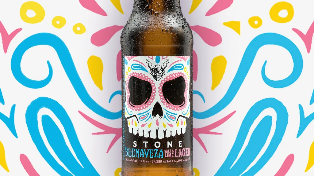 A condensation-covered Stone Buenaveza Salt & Lime Lager bottle against a colorful Day of the Dead-inspired illustrated background.