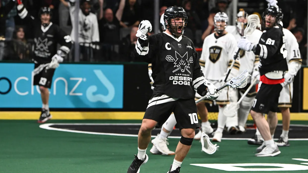 Las Vegas Desert Dogs captain #10 roars and pumps his fist in celebration after a goal during an indoor lacrosse game.