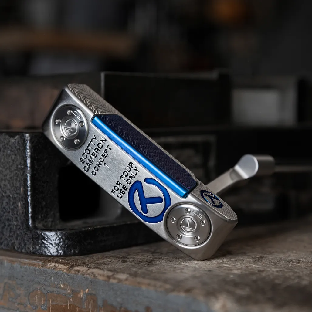Scotty Cameron Concept 1 Tour Use Only putter with blue paint fill and milled face, displayed on a workshop bench vice.