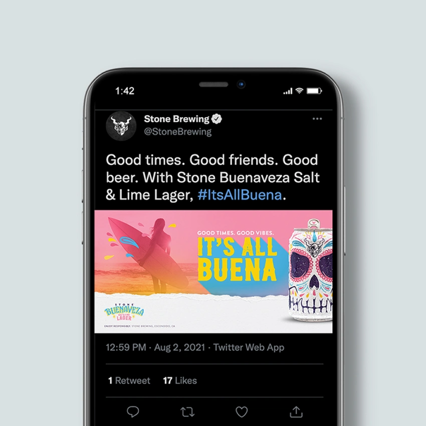 Phone mockup of a Stone Brewing tweet promoting Buenaveza Salt & Lime Lager with an "It's All Buena" beach surfer graphic.