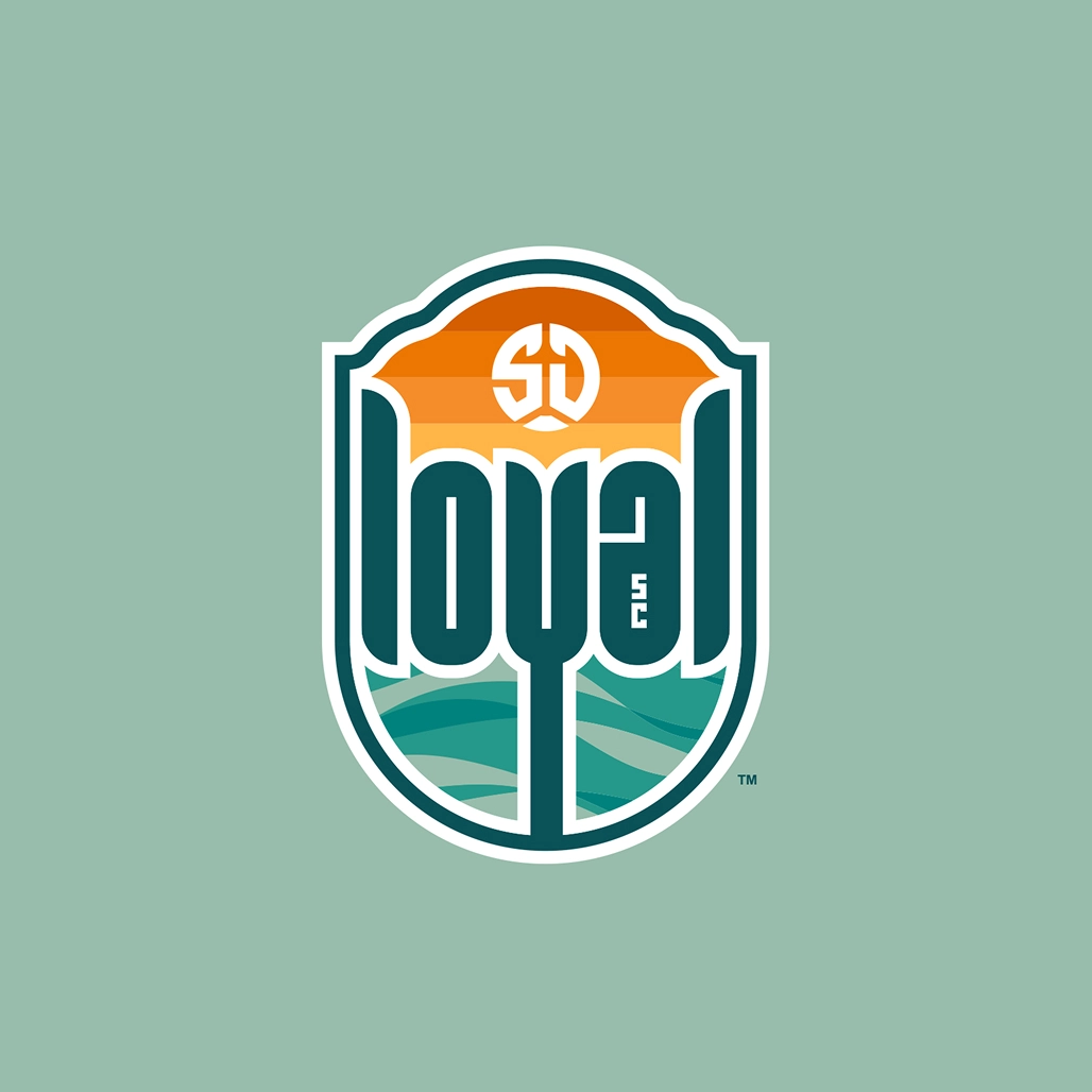 SD Loyal crest featuring orange sunset bands and teal ocean waves on a sage green shield.
