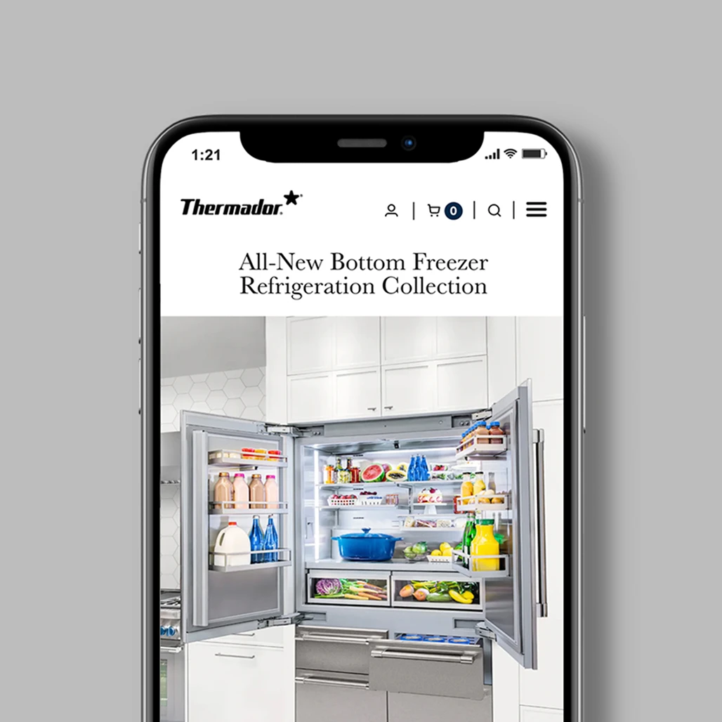 Smartphone showing the Thermador mobile site's All-New Bottom Freezer Refrigeration Collection page with an open built-in fridge.