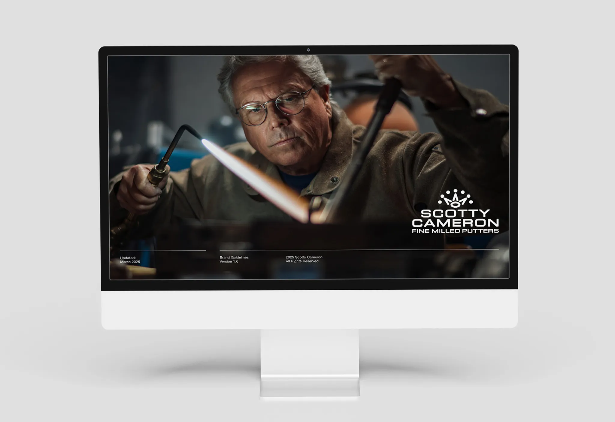 iMac mockup showing the Scotty Cameron Brand Guidelines cover, March 2025, Version 1.0, with a craftsman torching steel.