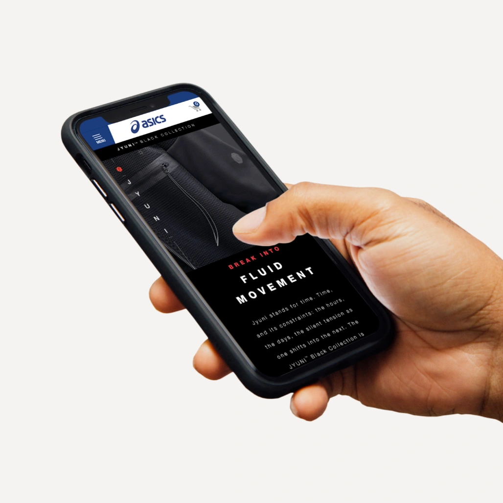 Hand holding a phone showing the ASICS JYUNI Black Collection mobile page with "Break Into Fluid Movement" headline