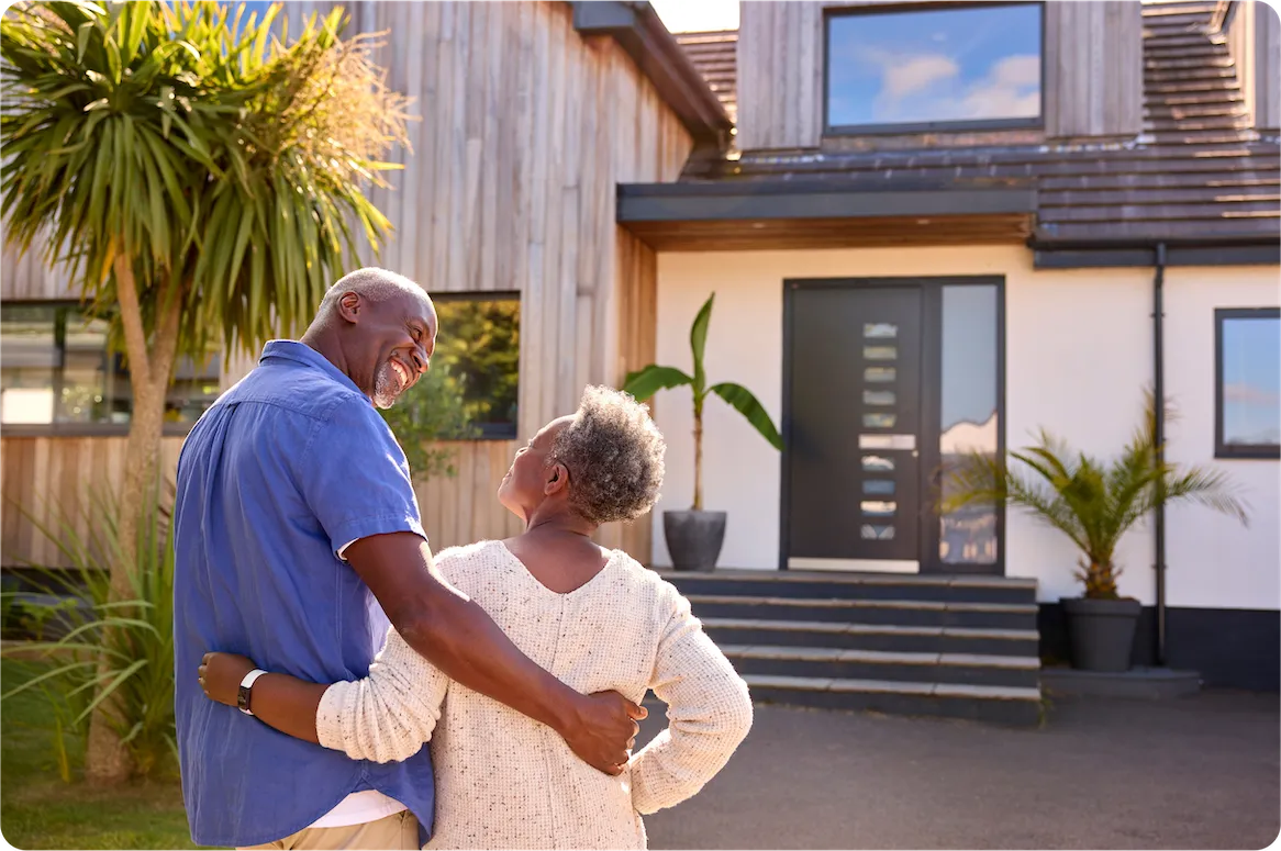 A picture of a couple admiring their home.