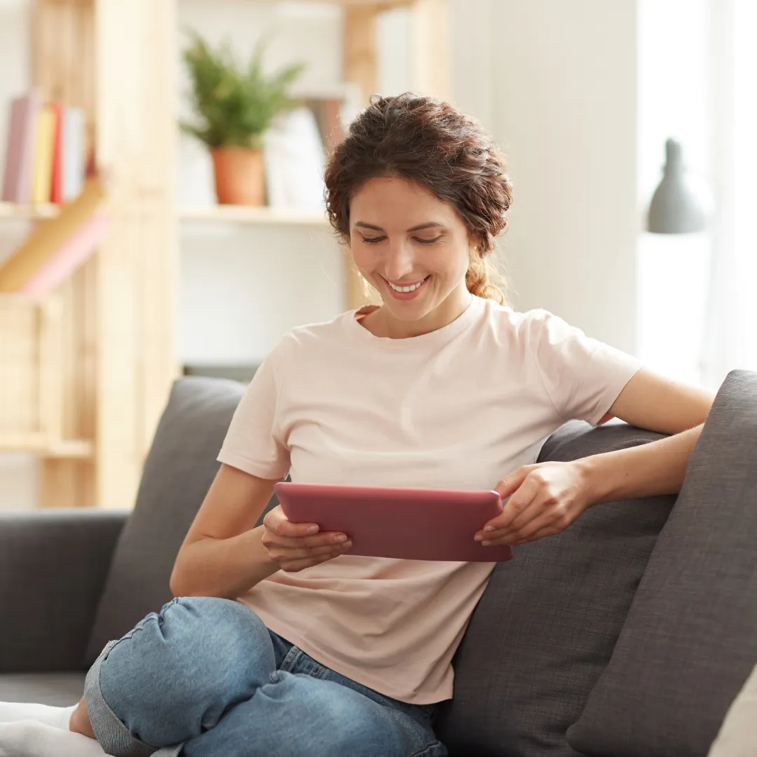 A woman using HouseFacts on a tablet managing her homes