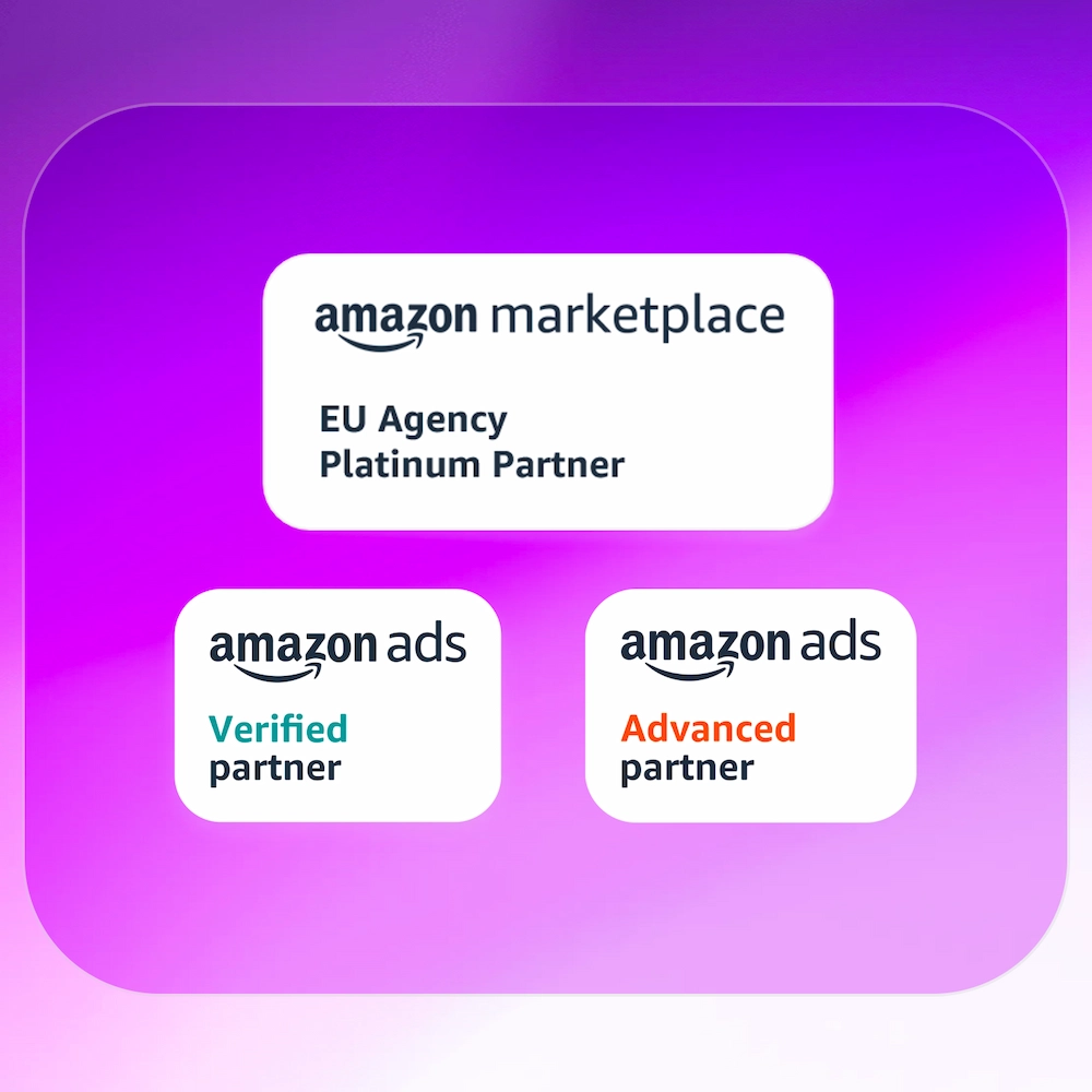 Man in glasses and black sweater arranging photos on a white brick wall.