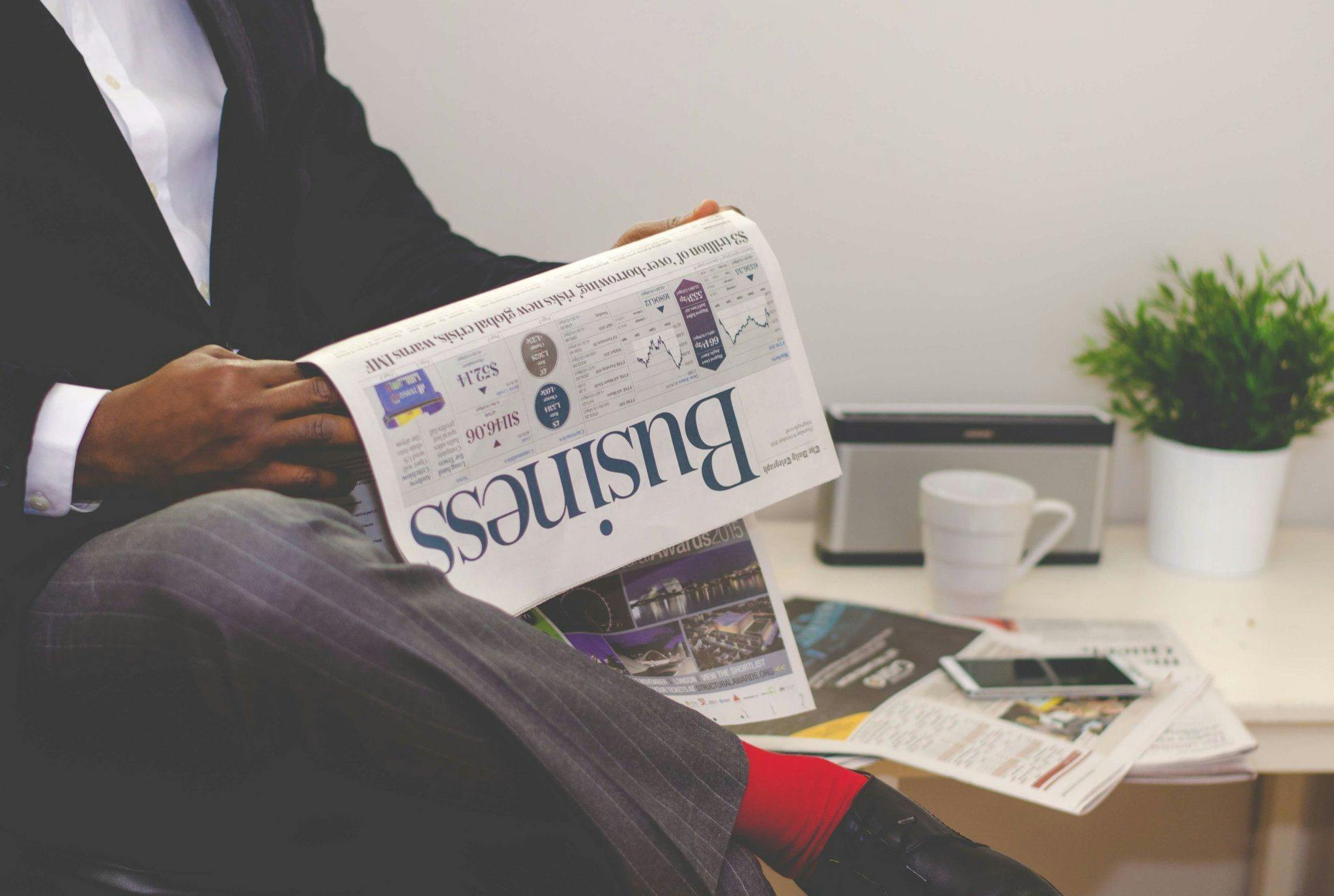 Person reading business newspaper.