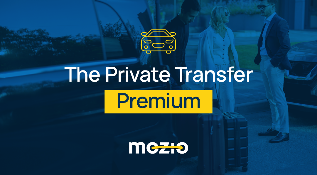 Travelers at an airport curb meeting a private transfer.
