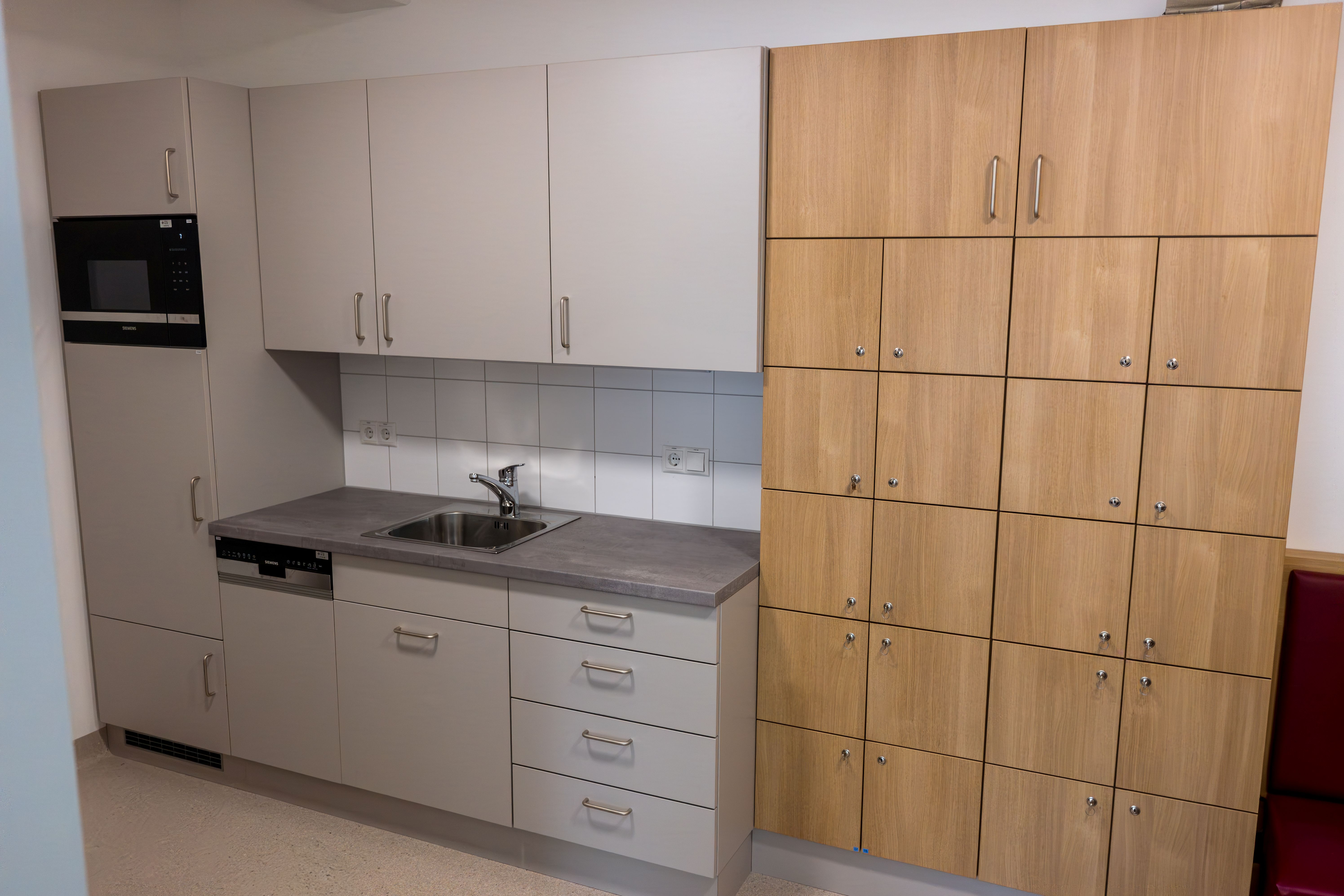 Graue Zeilenküche mit braunem Schrank