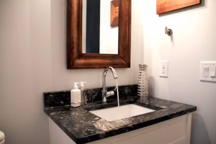 Harvested rainwater coming out of a bathroom faucet. Use rainwater like you would any other water!