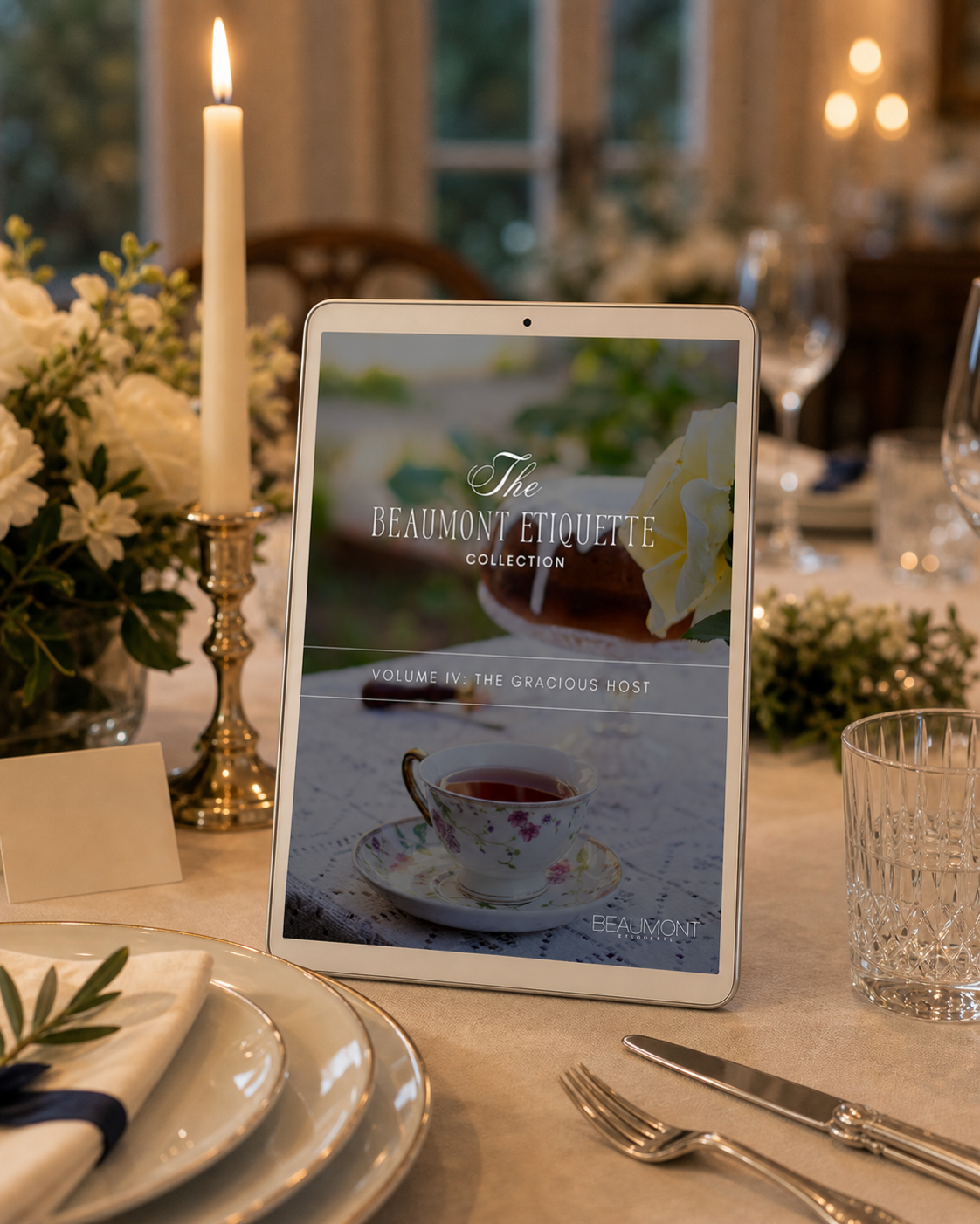 The Art of Hosting displayed on a tablet beside a prepared dinner-party table
