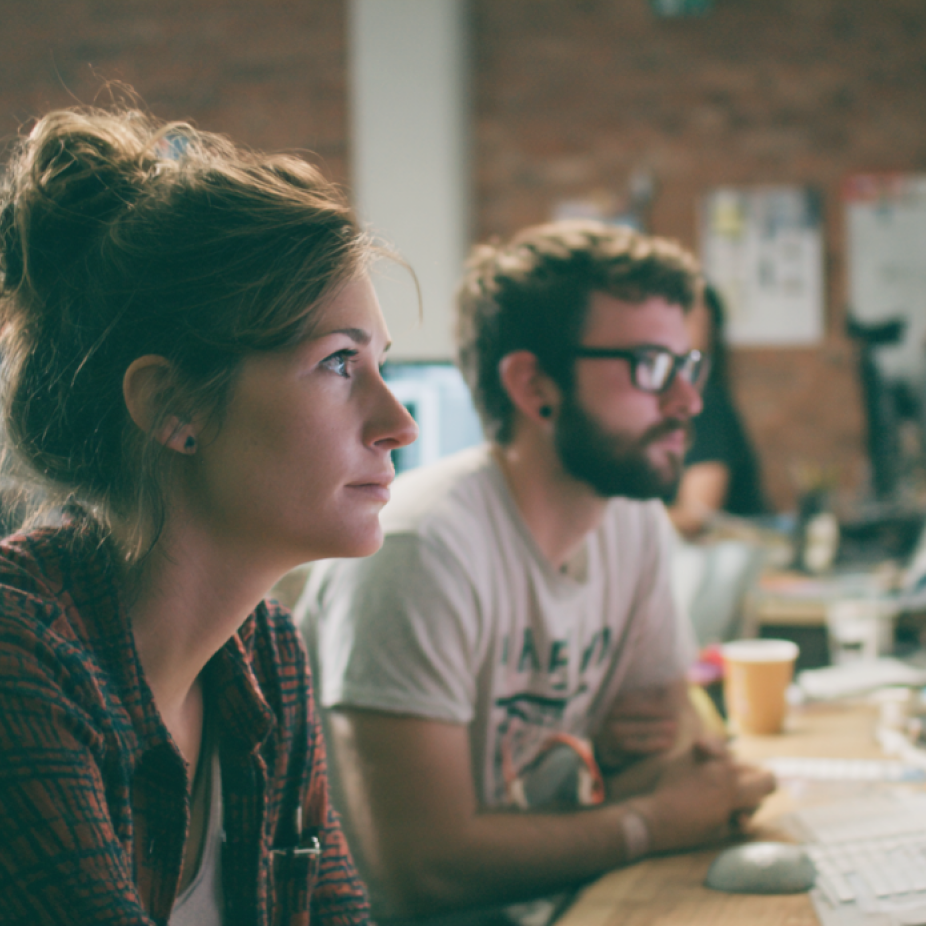 Creative professionals focused on digital project development in a collaborative studio, representing an experiential marketing agency environment.