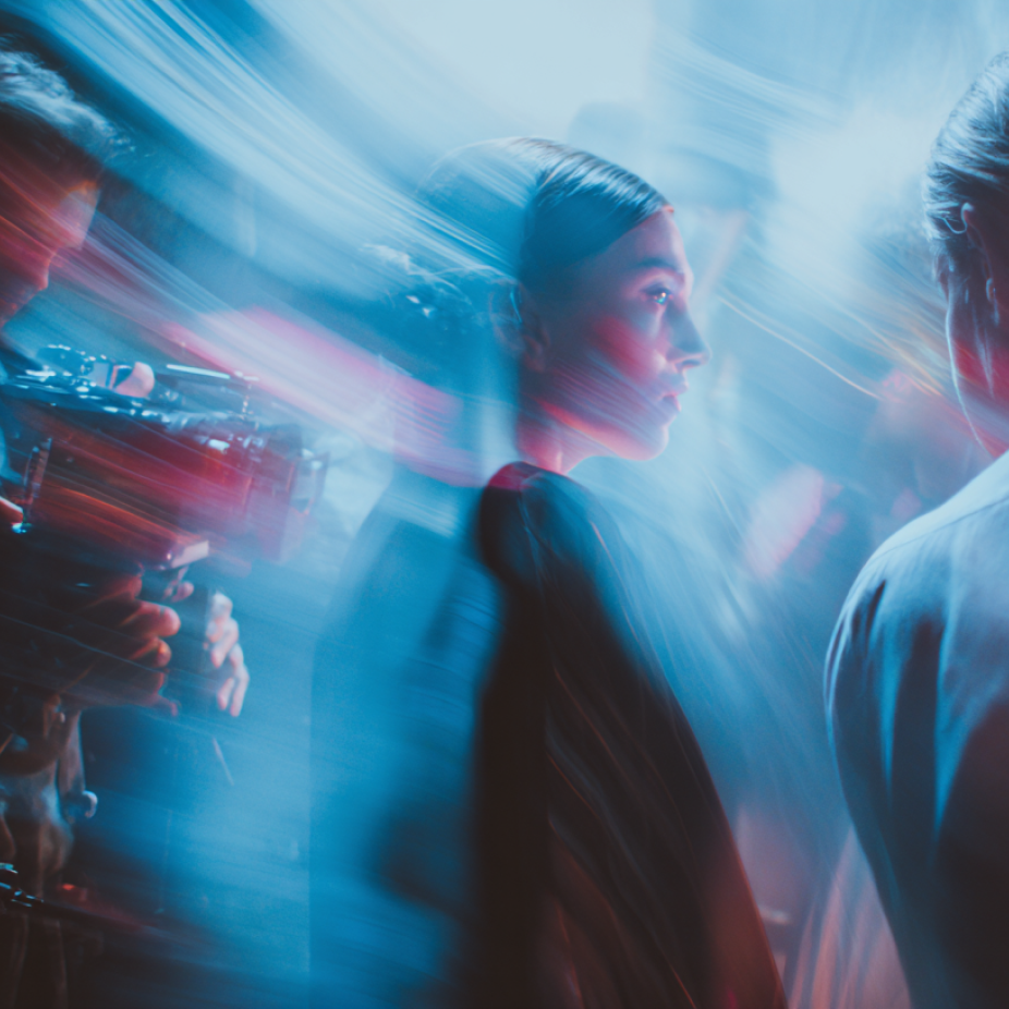Creative video production scene with cinematic lighting and camera crew capturing an actor in motion, reflecting the dynamic work of a video production agency.