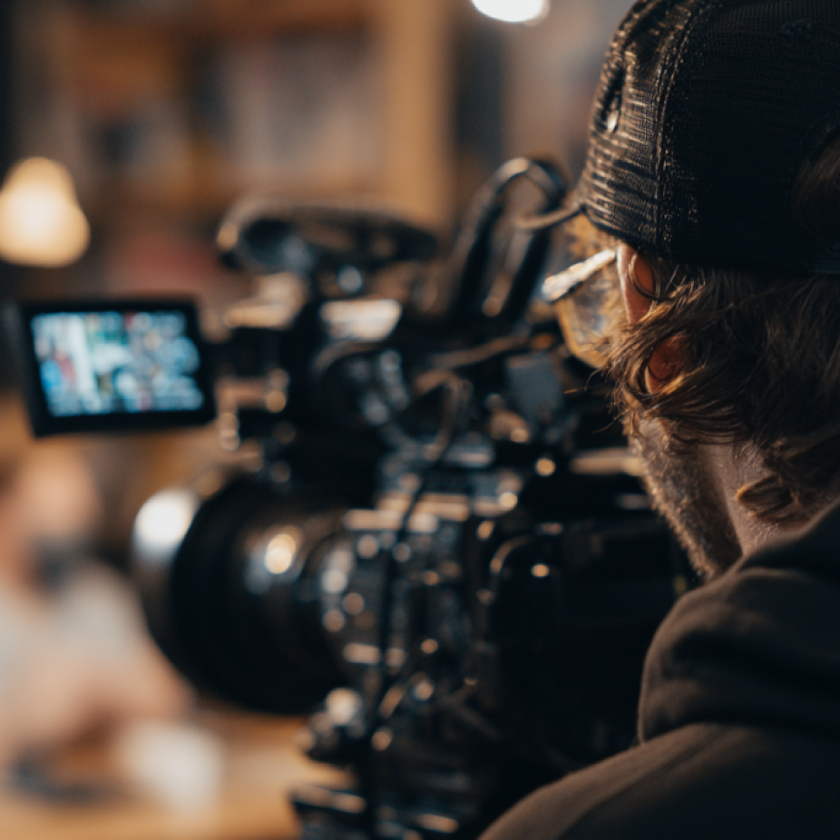 Cinematographer filming a creative scene with a high-end video camera, representing professional production work by a video animation agency.