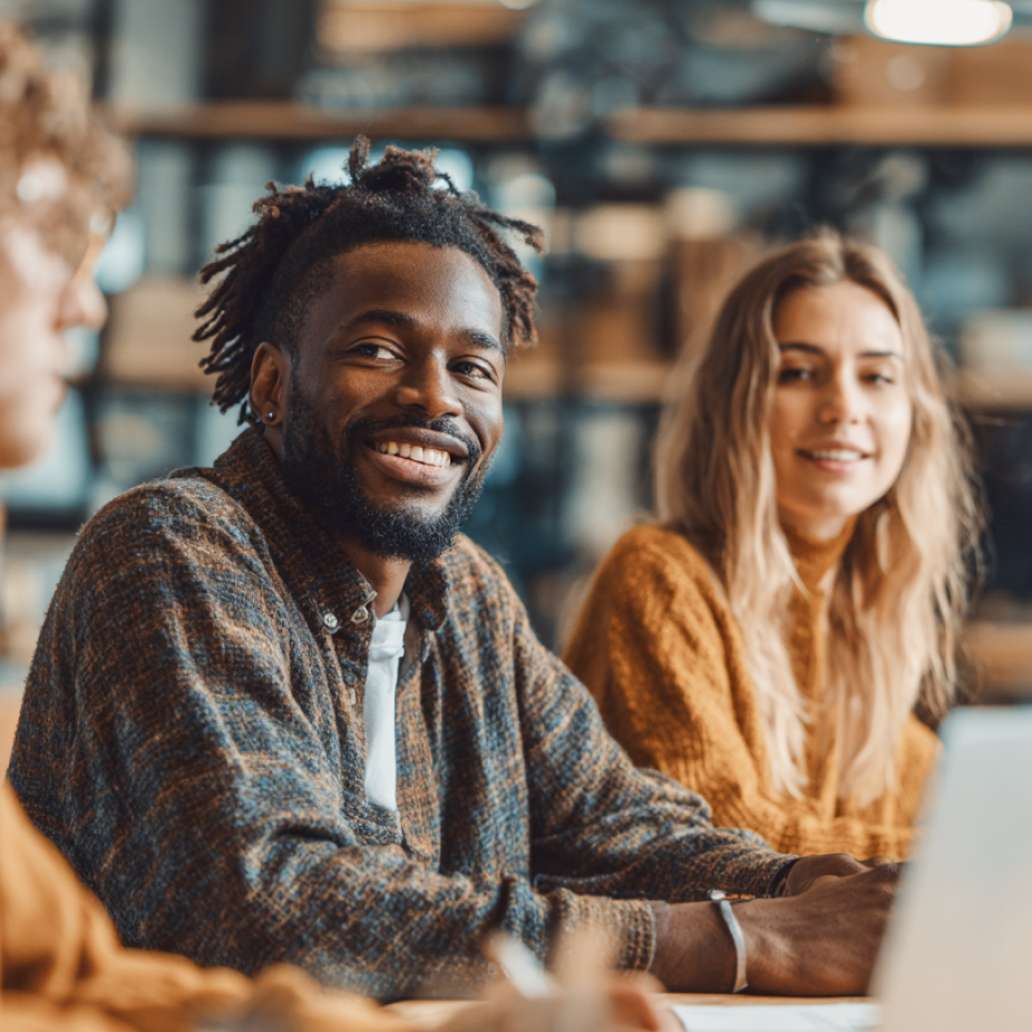Creative professionals collaborating in a casual studio setting, showcasing teamwork, innovation, and agency culture in a modern workspace.