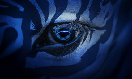 Close-up of a Zebra eye with dramatic blue lighting and zebra-like face paint pattern