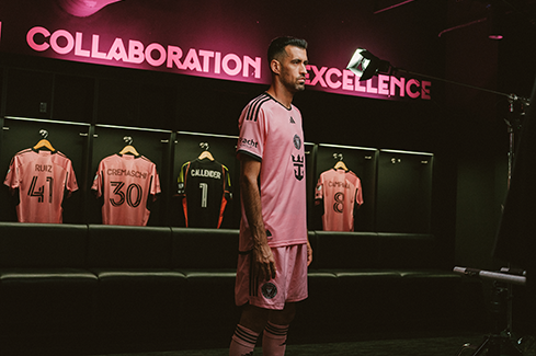 Soccer player posing in the locker room, representing co-branding and creative collaborations that connect teams and brands through design.