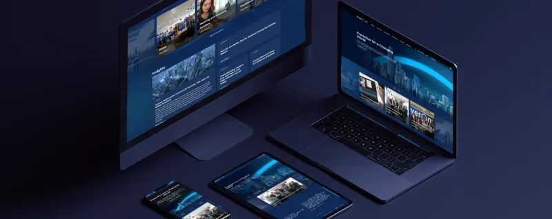 A laptop, monitor, tablet, and smartphone display the Everon Solutions website.