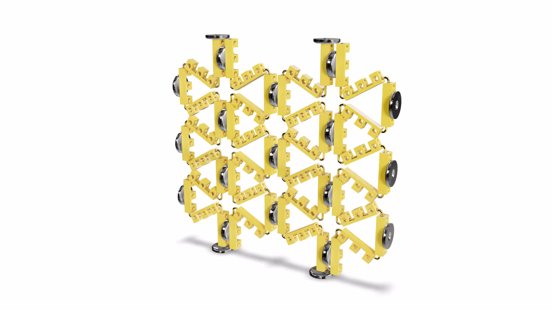 MUD Foundation Rafael Rodriguez Garciga’s Auxetic Unit Cell No. 2, featuring a three-dimensional yellow mechanical structure of repeating triangular units with black circular pivot points forming a grid-like auxetic pattern.