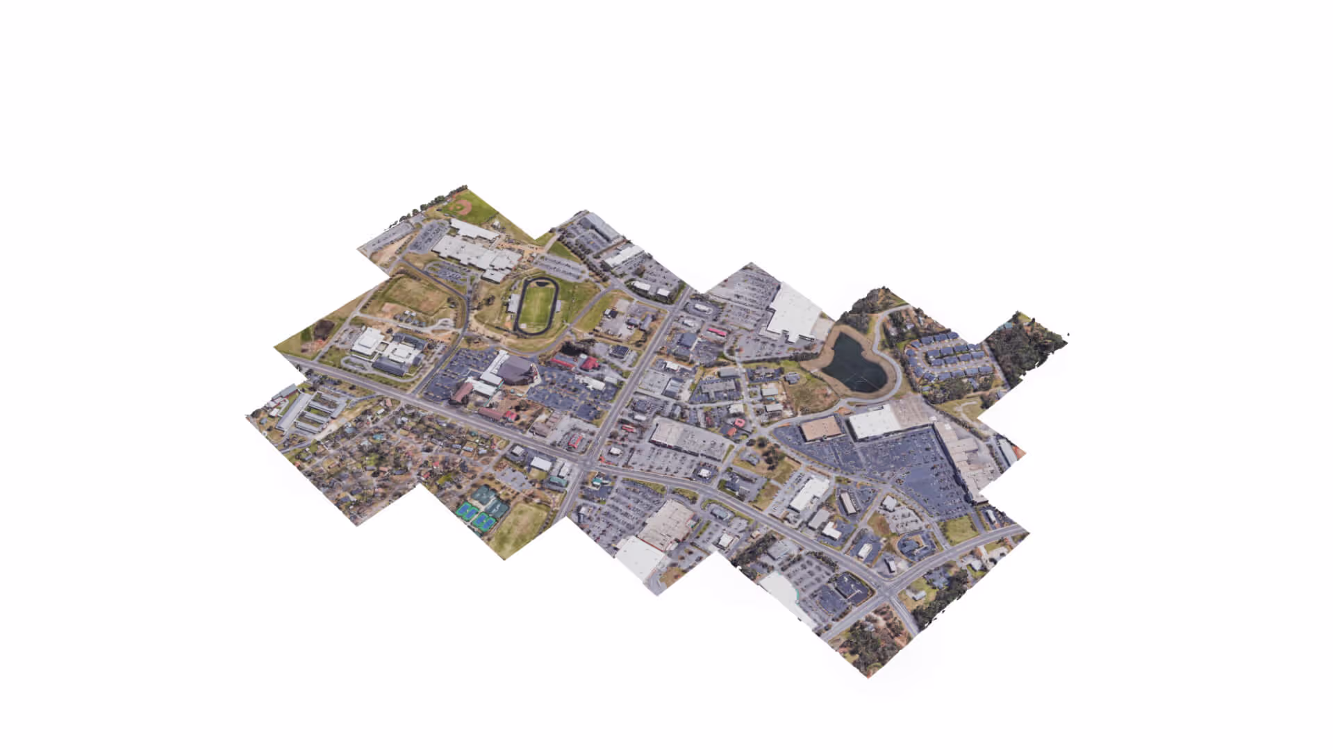 MUD Foundation Rodolfo Peraza’s Naked Link Pilgram 4.0 Map No-1, featuring an aerial view of an urban area with buildings, roads, parking lots, green fields, and a small body of water.