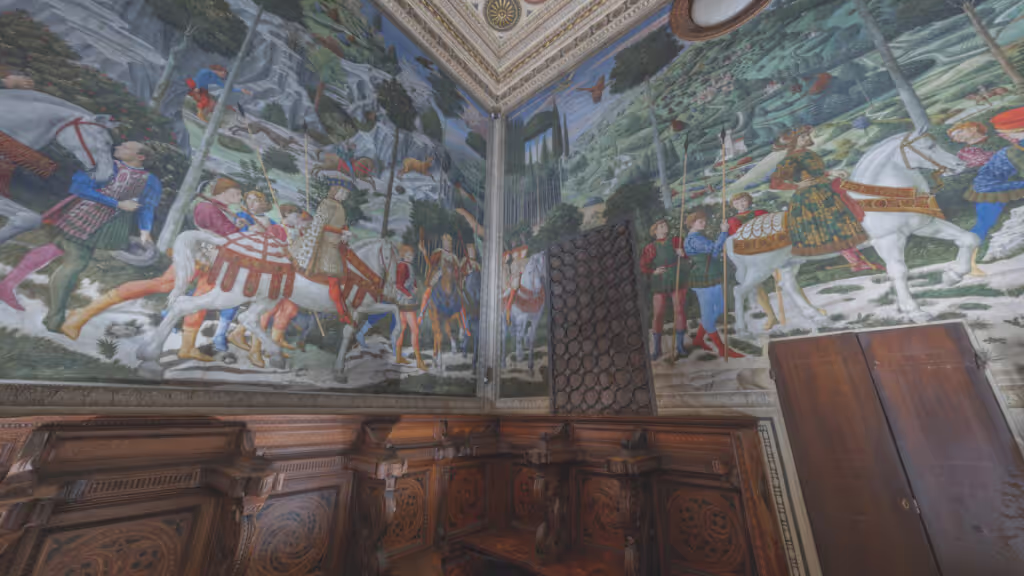 MUD Foundation XR Verse Benozzo Gozzoli’s Magi Chapel, featuring richly detailed Renaissance frescoes depicting a procession of people and horses in a lush landscape, above ornate carved wooden paneling.