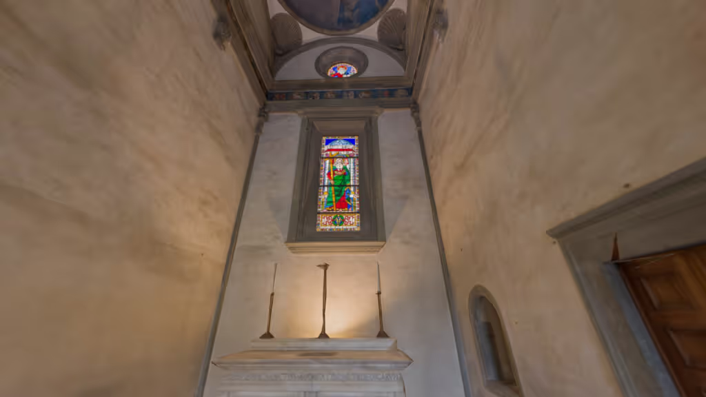 MUD Foundation Filippo Brunelleschi’s Pazzi Chapel in Verse, featuring a Renaissance chapel interior with a tall stained-glass window depicting a religious figure, flanked by candle holders and a partially visible wooden door.