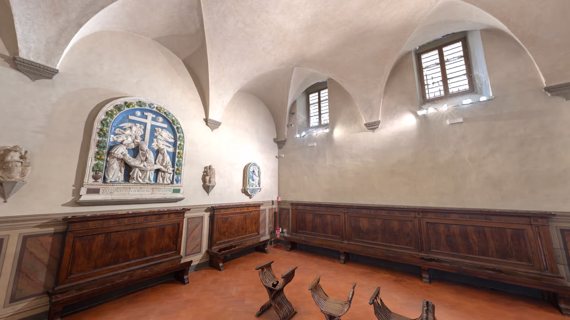 MUD Foundation Ghirlandaio Last Supper in Verse, featuring a historic Renaissance room with vaulted ceilings, wooden benches, terracotta flooring, and ceramic religious reliefs decorating the walls.