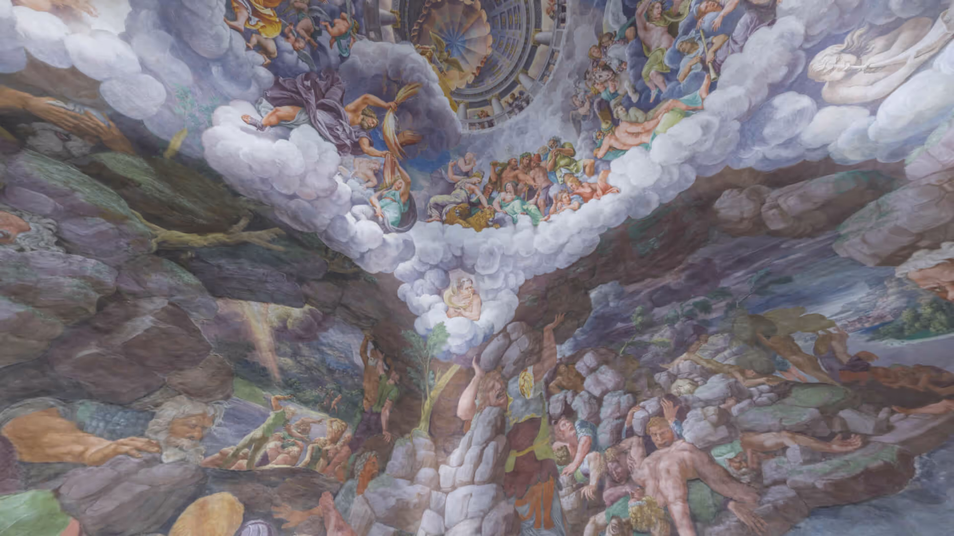MUD Foundation Giulio Romano’s Sala dei Giganti in Verse, featuring a dramatic mythological fresco ceiling with numerous human figures and gods surrounded by clouds, creating a swirling vortex effect within a grand architectural space.