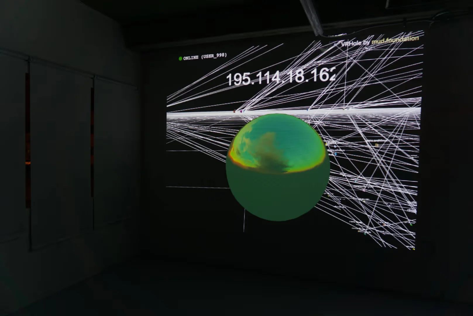 MUD Foundation Rodolfo Peraza’s *Pilgram 2.0: Naked Link (#DataViz)*, 2016, featuring a projected digital interface with a green sphere, white network lines, and numerical data displayed in a dark exhibition space.